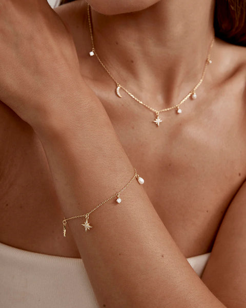 18k gold vermeil moon & star bracelet with freshwater pearls and cubic zirconia. Features an adjustable slider & diamond cut chain.