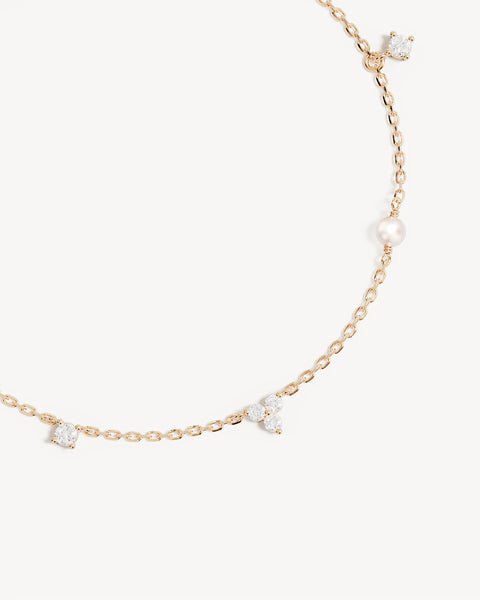18k gold vermeil lotus bracelet with freshwater pearls and cubic zirconia. Features an adjustable slider and diamond cut chain.