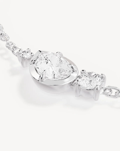 Macro close-up of the By Charlotte Quiet Radiance Bracelet in Sterling Silver, detailing the pear and round-cut cubic zirconia stones in claw and bezel settings.