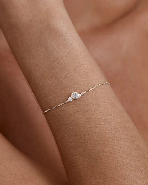 On-model wrist shot showing the delicate sterling silver diamond-cut chain and cubic zirconia feature of the By Charlotte Quiet Radiance Bracelet.