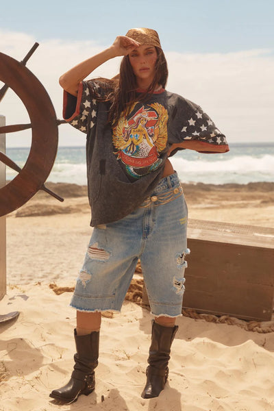 A close-up studio shot focusing on the front torso of the model in the Brenda graphic tee, detailing the rich textures of the 2026 heavy enzyme and oil wash vintage finish alongside the intricate winged-mermaid and heart illustrations.
