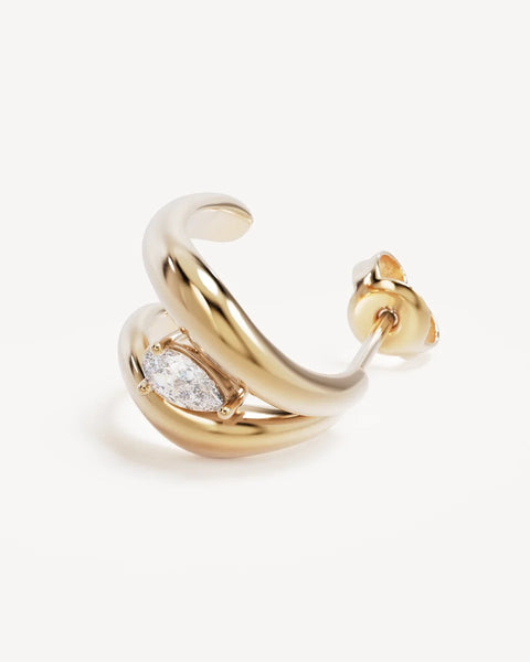 Detailed macro angle of a single By Charlotte Celestial Path Hoop in 18k gold vermeil, showcasing the double-band illusion curve and pear-cut cubic zirconia.