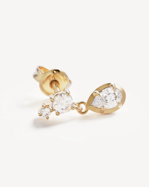 Close-up product view of a single By Charlotte Quiet Radiance Drop Stud Earring in 18k gold vermeil, featuring claw-set round cubic zirconias and a bezel-set pear-cut stone drop.