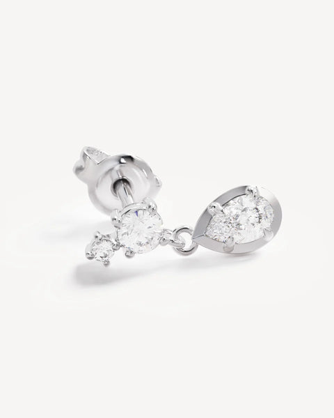 Close-up product view of a single By Charlotte Quiet Radiance Drop Stud Earring in sterling silver, featuring claw-set round cubic zirconias and a bezel-set pear-cut stone drop.