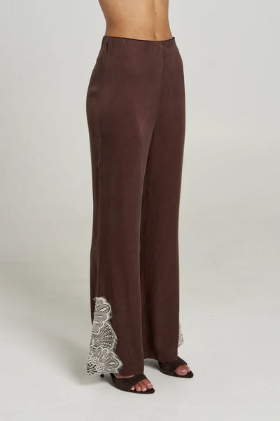 A side-profile studio product image of the Florence Pant in Espresso, emphasizing the seamless, sleek fit over the hips and the placement of the contrast cream lace insert at the hem.