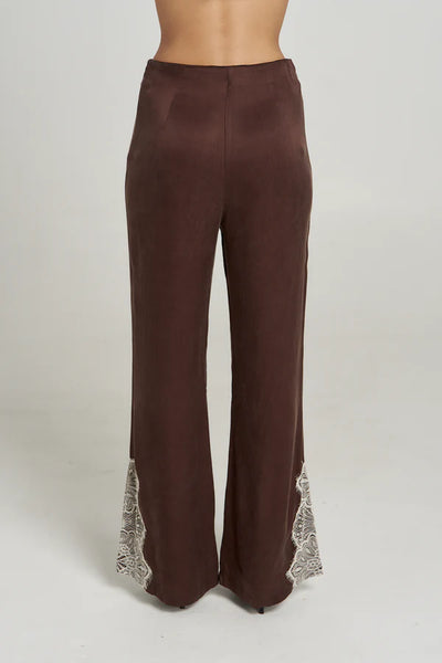 A rear-view studio product shot from the waist down, detailing the smooth back tailoring, high-waisted fit, and symmetrical lace trim detailing on the back cuffs of the Espresso brown pants.