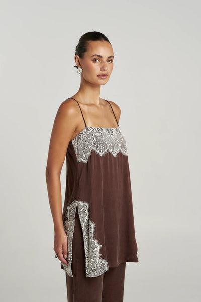 A three-quarter studio profile shot focusing on the side of the Florence Shift Top in Espresso, highlighting the delicate cream lace trim detailing along the hemline and the functional high split sides designed for effortless movement.