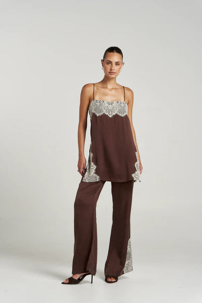 A full-length studio image of a model wearing the Summi Summi Florence Shift Top in Espresso with the matching pants and dark heels, demonstrating the top's relaxed silhouette and flowy cupro rayon drape.