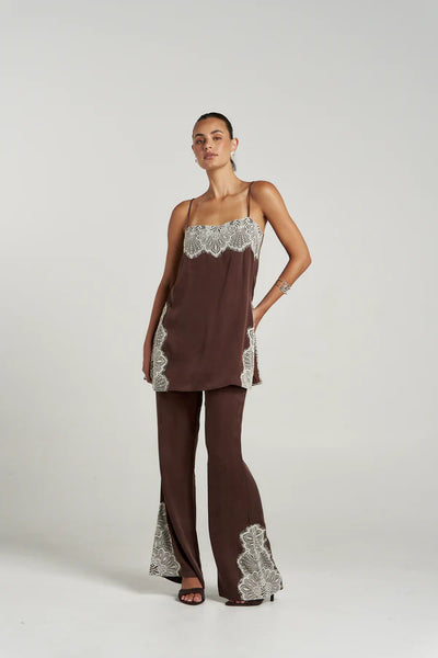 A front-facing studio image of a model wearing the tailored Espresso Florence Pant paired with its coordinating camisole top, showcasing the fluid drape and elegant movement of the cupro rayon blend fabric.