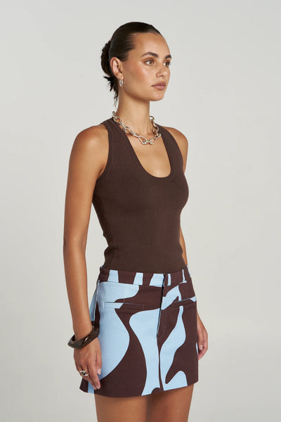 Three-quarter profile studio product shot of the soft 14-gauge organic cotton Halle Tank in Espresso, showcasing its clean scoop neckline, wide shoulder straps, and premium form-fitting construction.