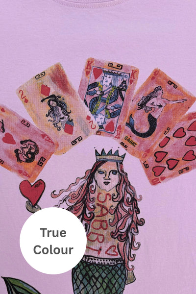 Close-up view of the hand-drawn playing cards and mermaid artwork on the front of Sabbi The Very Oversized Lucky Mermaid Tee in Bright Pink.