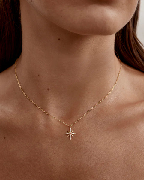 18k gold vermeil star necklace with lab-grown pink sapphire and cubic zirconia. Features an adjustable slider for a custom fit