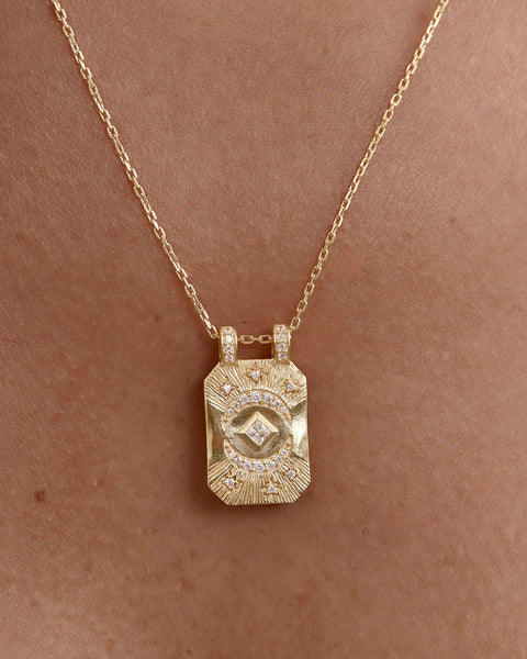Gold necklace with a pendant features an adjustable slider, cubic zirconia, and diamond cut chain