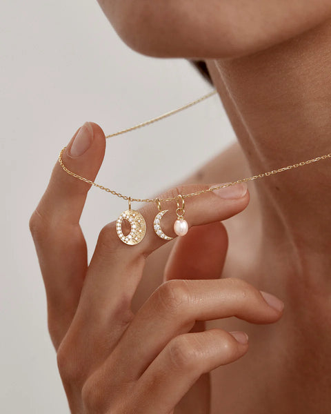 Gold necklace with moon and pearl pendants 