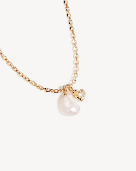 18k gold vermeil necklace featuring a freshwater baroque pearl and heart pendant. Includes an adjustable slider and signature diamond cut chain.