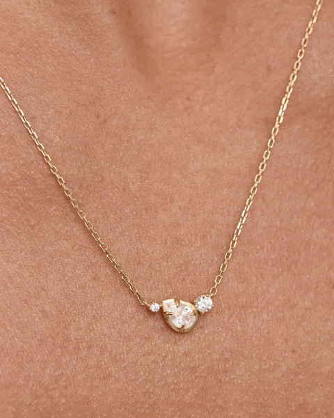Close-up on-model shot showcasing the pendant detail of the By Charlotte Quiet Radiance Necklace in 18k gold vermeil.