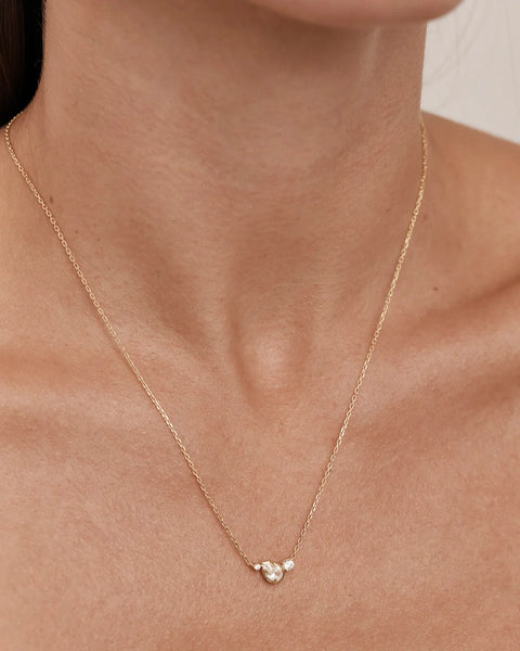 On-model portrait shot displaying the By Charlotte Quiet Radiance Necklace in 18k gold vermeil worn around the neck.