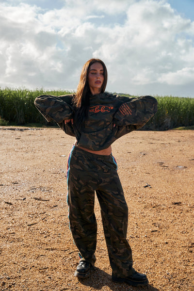 A front studio view of the relaxed-fit sweat pants featuring a heavily enzyme-washed camo print and a comfortable elastic waistband with an adjustable drawcord.