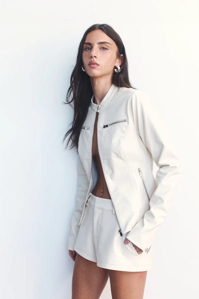 A close-up of the front princess panelling on the Tari jacket, highlighting the structured fit and smooth cream faux-leather texture.