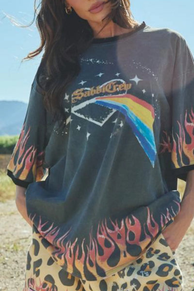 A close-up studio detail shot focusing on the front lower torso print of the tee, showcasing the high-density screen-printed gradient detailing of the exclusive rainbow prism and celestial motifs on the soft cotton fabric.