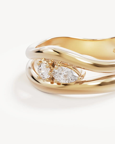 Extreme macro view of the By Charlotte Celestial Path Ring in 18k gold vermeil, detailing the dual-band construction and central pear and round cubic zirconias.