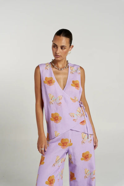 Full-length studio shot of a model wearing the complete Summi Summi Reverie set, featuring the wrap tie front vest paired with wide-leg matching printed pants.