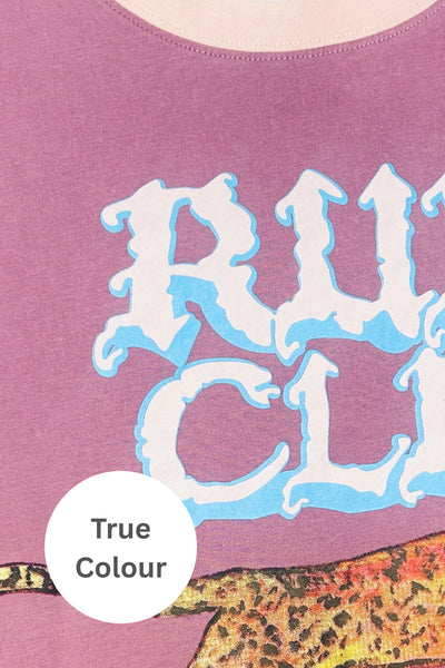 A flat-lay studio product photograph of the Very Oversized Run Club Tee in bright pastel pink. The shirt is displayed flat against a clean white background, showcasing its boxy, relaxed shape, contrasting vibrant green crew neckline, and the large vintage-style varsity text graphic printed across the front.