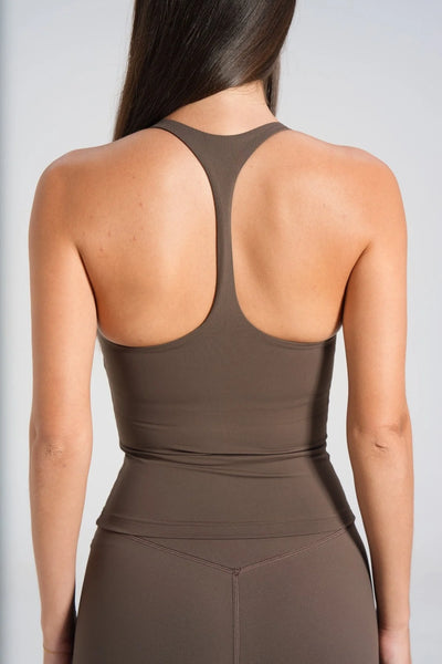 Close-up studio rear view focusing on the narrow racerback cut and upper back coverage of a dark chocolate brown athletic tank top.
