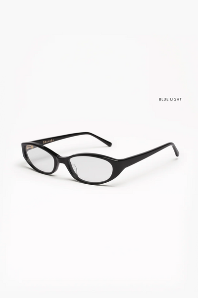 Three-quarter studio product shot of the SHEVOKE Silon black acetate blue-light glasses showing the fine frame silhouette and gold temple hinge details.