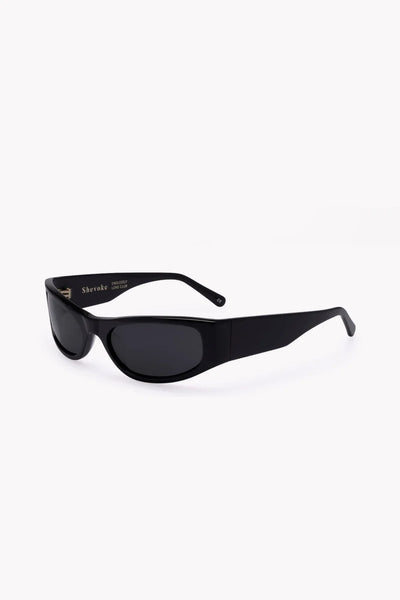 Three-quarter side studio view of the glossy black wrap-around sunglasses showing the thick arms and tinted lenses.