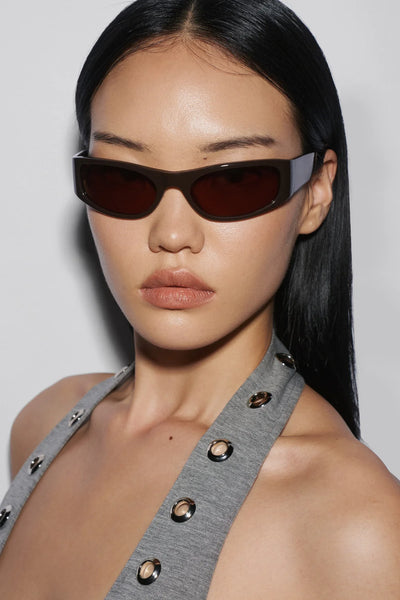 Three-quarter front view of a model wearing the SHEVOKE Jen 002 sporty brown wrap sunglasses with CR39 tinted lenses.