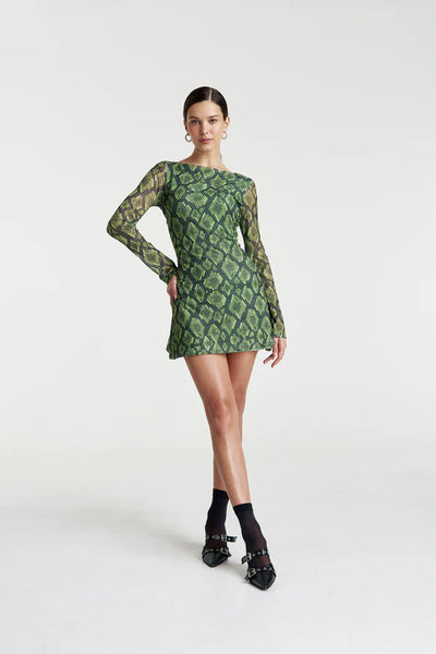 Model in the Hibernate A-Line Mini Dress, showcasing the vibrant green and black Viper snake print and the sheer mesh long sleeves.