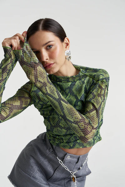 An editorial pose showcasing the Mesh LS Rouched Skivvy in Viper, emphasizing the lightweight 96% polyester mesh and bold animal motif.