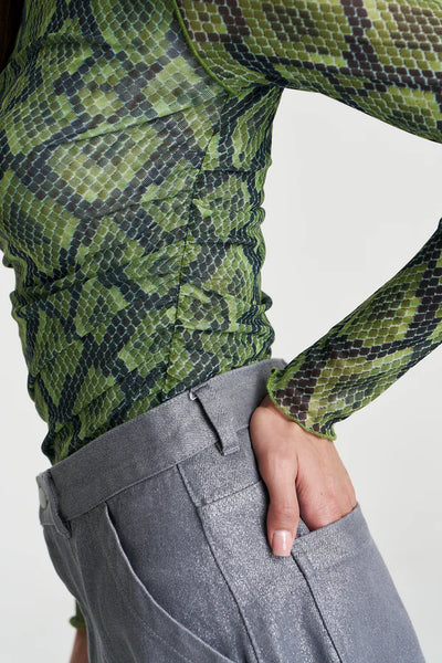 A side-profile detail focusing on the functional side-seam, showcasing the rouched construction that creates a flattering, textured drape across the waist.